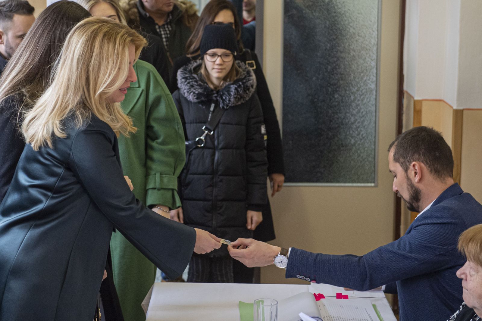 Na snímke prezidentka SR Zuzana Čaputová preukazuje svoju totožnosť členovi okrskovej volebnej komisie vo volebnej miestnosti vo voľbách do Národnej rady SR v Pezinku, 29.februára 2020.